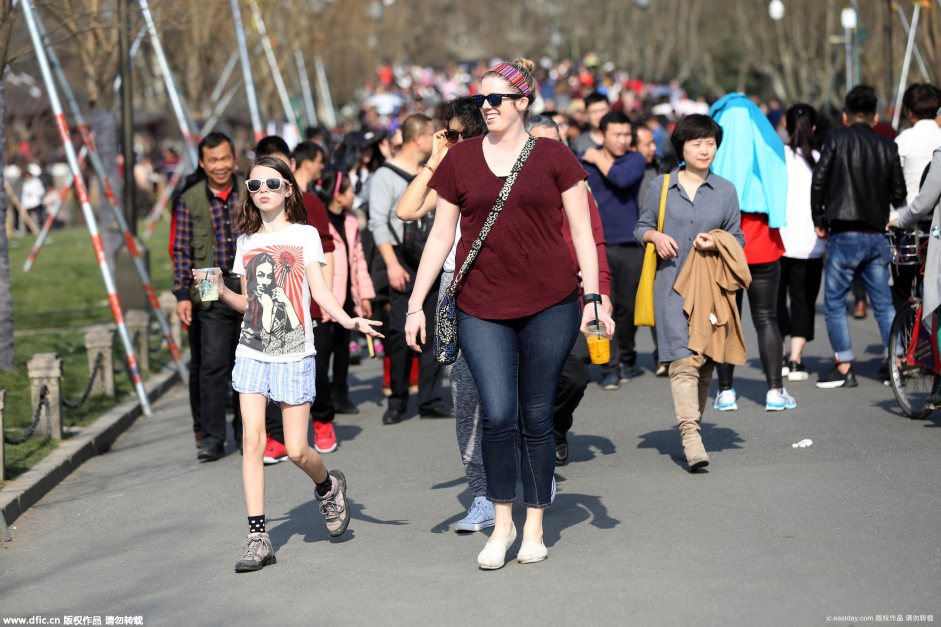 People in flowy summer dress in Hangzhou on fifth day of New Year