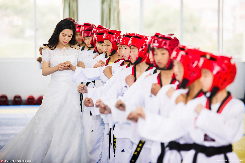 A couple take taekwondo-themed wedding photos