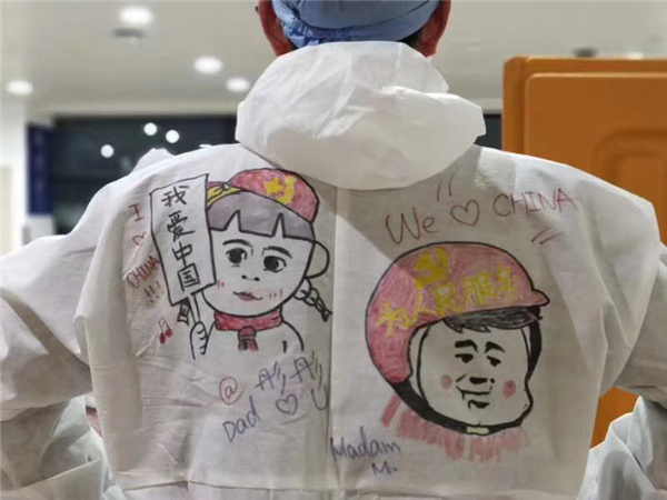 Frontline workers at airport decorate protective gear  