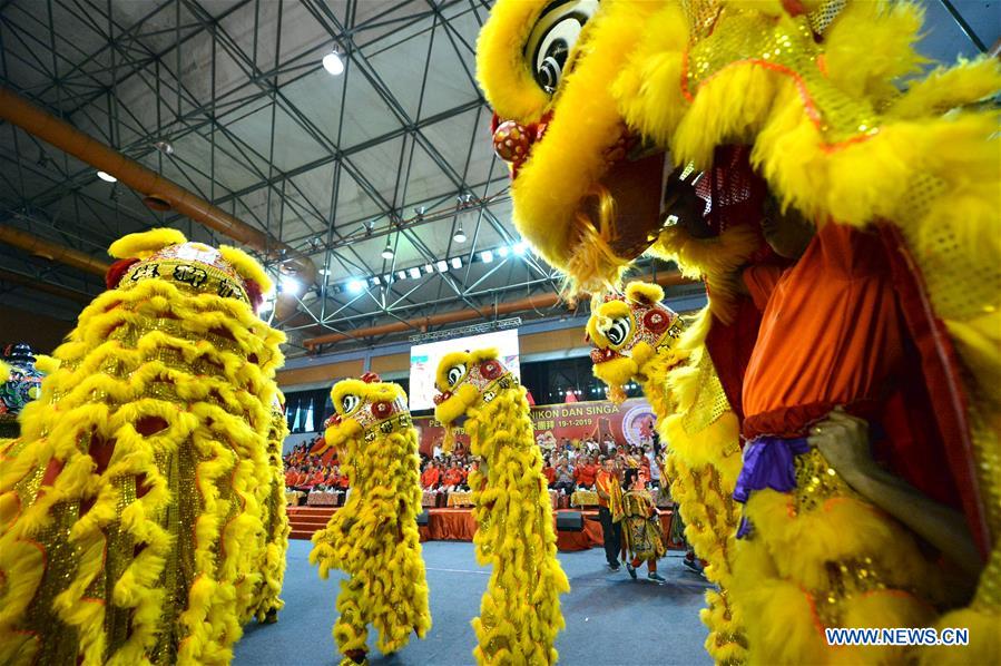 People perform lion dance to celebrate upcoming Chinese Lunar New Year in Malaysia